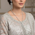 Silver necklace with tassel earrings on a black background