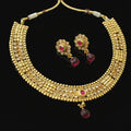 Gold necklace and earrings with red stones on a dark background, branded 'Saheli'.