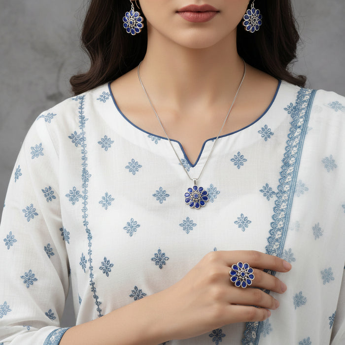 Jewelry set with blue floral designs on a gray background