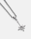 The SAME X STATEMENT "Inversion" Pendant Small by Statement Collective is a silver chain necklace with pointed edges and a cut-out clover design, inspired by RPG jewelry, shown on a plain light background.