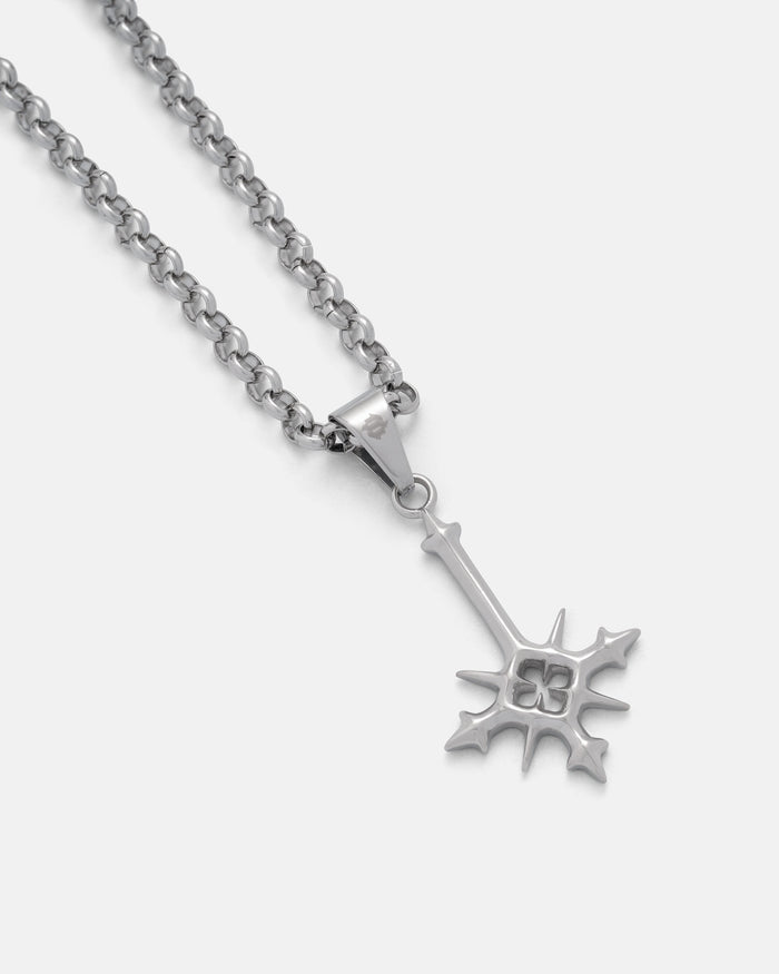 The SAME X STATEMENT "Inversion" Pendant Small by Statement Collective is a silver chain necklace with pointed edges and a cut-out clover design, inspired by RPG jewelry, shown on a plain light background.
