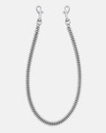 Silver spiked Cuban wallet chain with 2mm spikes on either side for a brutalist feel. Silver heavy duty hardware clips to hook onto you belt loops. on grey background.