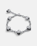 Silver 6mm Cathedral chain bracelet with skull charms around and a 2.5cm Extender by statement collective on grey background.