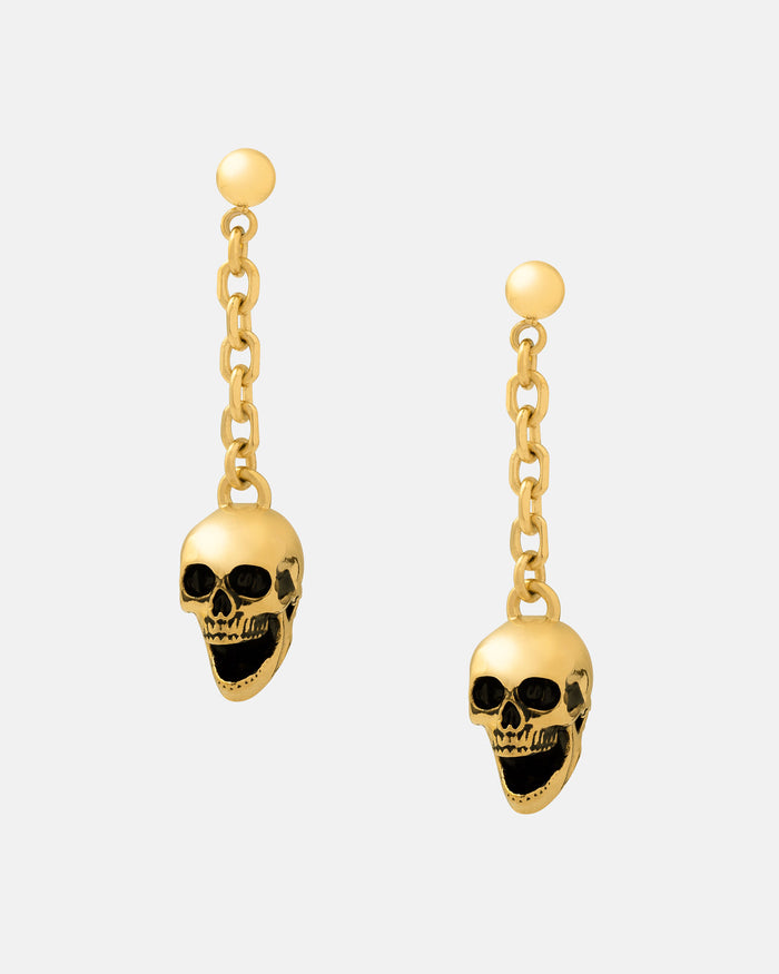 Skull Drop Earrings (Gold): 18k gold-plated, waterproof, and hypoallergenic dangle earrings featuring small chain links and detailed skull charms, shown on a plain light gray background.