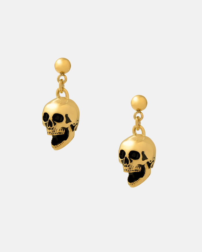 The Skull Earrings (Gold) are 18k gold-plated drop earrings with dangling skull charms, black accents, and small round studs—perfect rock punk jewelry for a bold statement.
