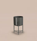 Small black pot on stand