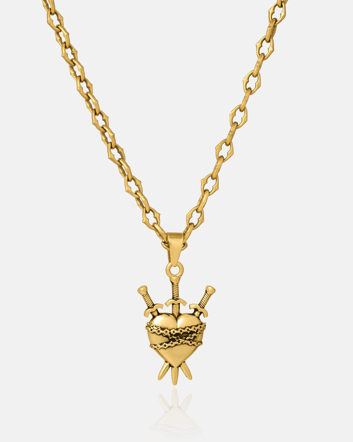 The Cathedral" 6mm Spiked Chain in gold with a custom pendant option is shown on a reflective white background.