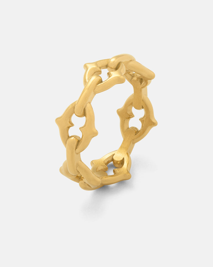 Introducing “The Cathedral” Spiked Ring (Gold) by Statement Collective—a bold 18k gold ring boasting a unique chain-link design. Interlocking links are sculpted into stylized floral motifs, capturing the dramatic elegance of a gothic chain ring. Showcased against a plain white background, this distinctive piece is both eye-catching and timeless.