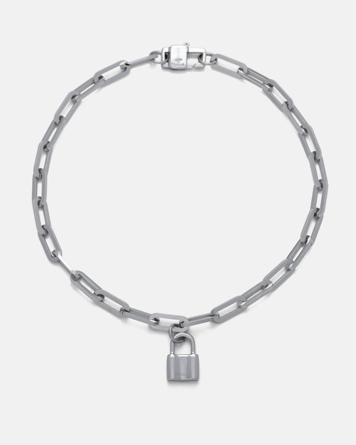 The Dainty Charm Choker (Custom Pendant Choice) features a silver paperclip chain with elongated links and a small silver padlock pendant at the center, shown on a plain white background.