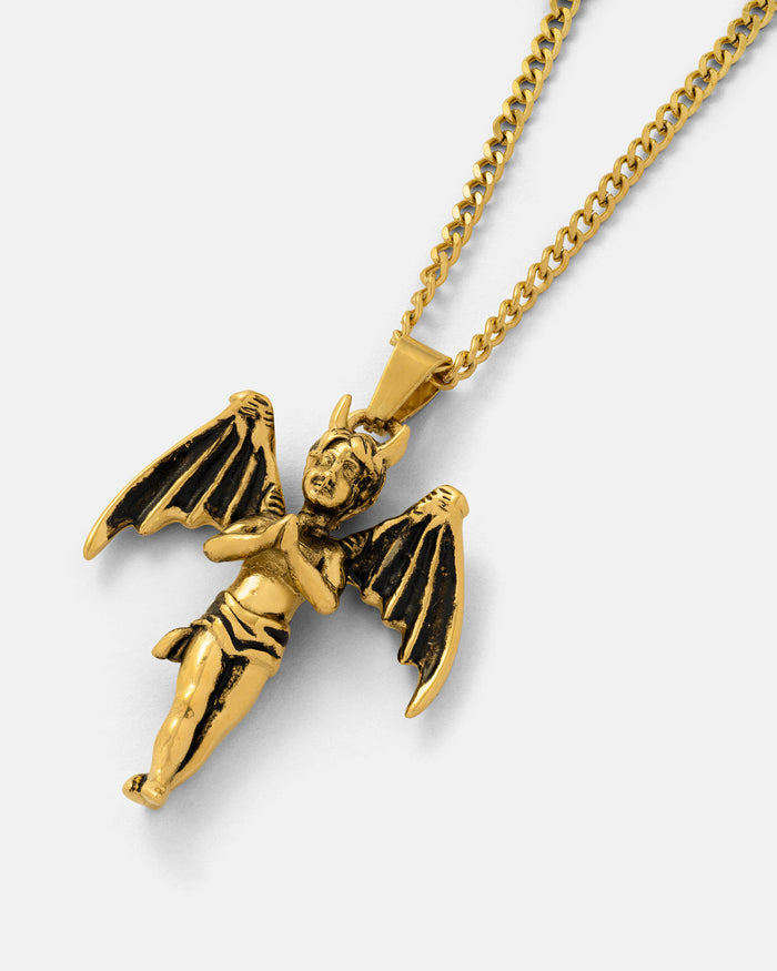 The Wicked One" Pendant (Gold) is a gothic necklace showcasing a winged cherub with small horns and bat-like wings, crafted in 18k gold-plating and displayed against a plain light background.