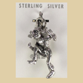 Vintage Maisel's Sterling Silver Dancer Charm, New Old Stock, shown on a desert plaster background