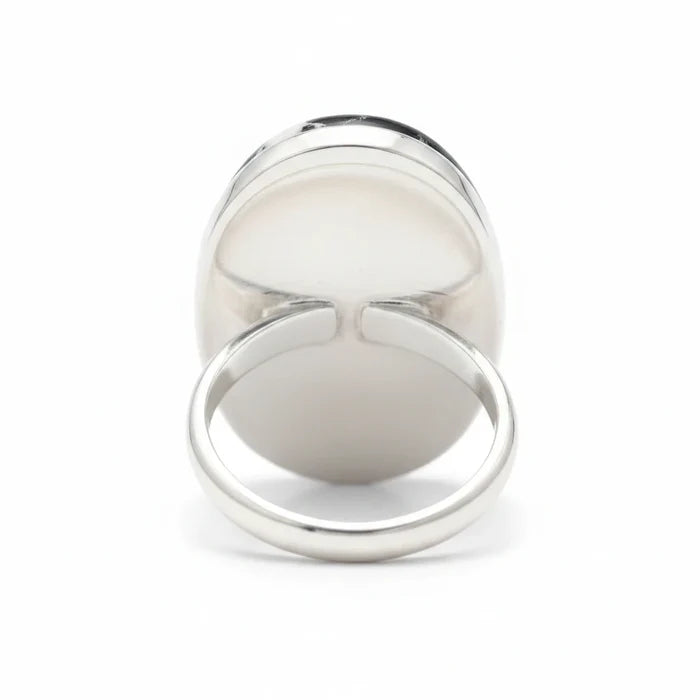 Wildflower Artisans sterling silver ring featuring an oval White Buffalo stone with black matrix, back view.
